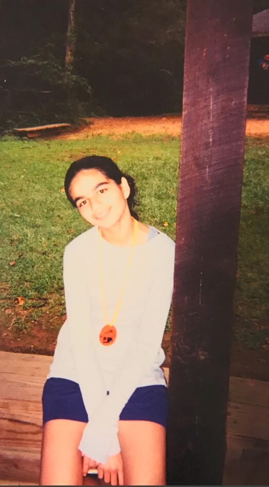 Amber's sister sitting outdoors