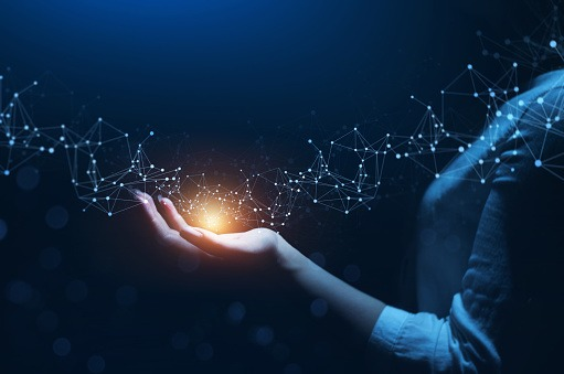 A hand reaching upward, illuminated by a network of light